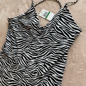 Zebra stripped jumpsuit. Cross cross back, side zipper. Never worn - tags on